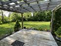 Relaxing backyard patio with pergola, overlooking a spacious lawn with manicured landscaping at 526 Emerson Rd, Carmel, IN 46032
