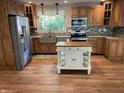 Charming kitchen with wood cabinets, granite countertops, stainless appliances, and center island at 526 Emerson Rd, Carmel, IN 46032