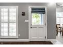 Bright interior showcasing a white shuttered window and paneled door with backyard views at 608 E 9Th St, Indianapolis, IN 46202