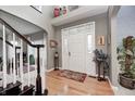 Bright foyer with decorative glass door, hardwood floors, a staircase, and an elegant decorative touch at 7002 Oakbay Cir, Noblesville, IN 46062