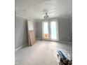 Neutral bedroom featuring double doors and a ceiling light fixture at 7309 Bayview Run, McCordsville, IN 46055