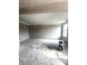 Unfinished living room with neutral paint, bare floors, and a window letting in natural light at 7313 Bayview Run, McCordsville, IN 46055