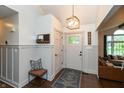 Inviting entryway featuring a stylish bench, coat rack, and modern lighting fixture at 8140 Springwater W Dr, Indianapolis, IN 46256