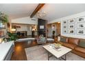 Cozy living room with a fireplace, hardwood floors, and an open layout to the kitchen at 8140 Springwater W Dr, Indianapolis, IN 46256