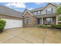 Charming brick and siding home boasts a spacious driveway, attached garage, and lovely landscaping at 8663 N Commonview Dr, McCordsville, IN 46055