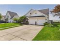 Charming two-story home boasts a two-car garage, complemented by a well-maintained lawn and landscape at 9635 Shasta Dr, Fishers, IN 46038