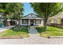 Charming single-story home with a gravel path and lush green lawn, framed by mature trees at 110 Highland Ave, Franklin, IN 46131