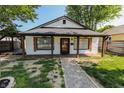 Inviting single-story home with a gravel path, showcasing its covered front porch and dark window shutters at 110 Highland Ave, Franklin, IN 46131