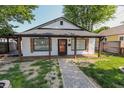 Inviting single-story home with a gravel path, showcasing its covered front porch and dark window shutters at 110 Highland Ave, Franklin, IN 46131