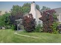 Inviting front exterior with lush landscaping, walkway, and a classic architectural style at 1141 N Shadeland Ave, Indianapolis, IN 46219