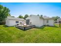 Spacious backyard with a wooden deck, outdoor seating, and lush green lawn perfect for entertaining at 120 Hoss Rd, Indianapolis, IN 46217