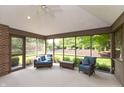 Bright sun room featuring neutral carpet, casual furniture and windows with wooded views at 1220 Pintail Ct, Columbus, IN 47201