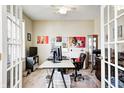 Bright office with neutral walls, carpeted floors, and double French doors providing ample natural light at 13068 Lamarque Pl, Fishers, IN 46038