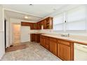 Functional kitchen featuring wood cabinets, neutral countertops, and natural light at 1346 W 27Th St, Indianapolis, IN 46208