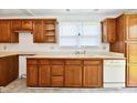 Functional kitchen featuring wood cabinets, neutral countertops, and natural light at 1346 W 27Th St, Indianapolis, IN 46208