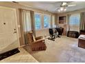 Comfortable living room with a carpeted floor, large windows, and neutral colored walls at 1437 E Pleasant Run Pkwy S Dr, Indianapolis, IN 46203