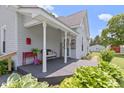 Inviting covered porch with seating, plants, and a decorative door, perfect for relaxing at 1539 Evans Ave, Noblesville, IN 46060