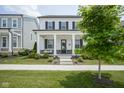 Charming two-story home with a welcoming front porch with swing and meticulously landscaped front yard at 15557 Starflower Dr, Westfield, IN 46074