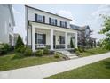 Inviting front porch featuring stately white columns and relaxing porch swing at 15557 Starflower Dr, Westfield, IN 46074