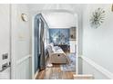 Cozy living room with hardwood floors and an arched doorway into a comfortable seating area at 1621 Beeler Ave, Speedway, IN 46224
