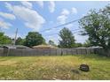 Spacious backyard with a wooden privacy fence, offering a secure and serene outdoor space at 1628 Edgewood Dr, Anderson, IN 46011