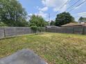 Fenced backyard with grass and partially shaded area, perfect for outdoor activities at 1628 Edgewood Dr, Anderson, IN 46011