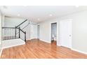 This spacious living room features stairs, hardwood floors and a convenient powder room at 174 Straughn Ln, Westfield, IN 46074