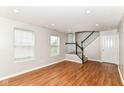 The living room features recessed lighting, hardwood floors and access to the staircase at 174 Straughn Ln, Westfield, IN 46074
