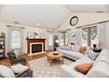 Bright living room featuring a fireplace, vaulted ceilings, and ample natural light at 1783 Cloister Dr, Indianapolis, IN 46260