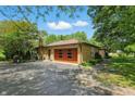 View of the side of the home with a large wooden garage door and paved driveway at 1914 S Avon Ave, Avon, IN 46123