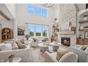 Stunning living room with stone fireplace, soaring ceilings, and large windows with view at 19652 Shadow Trace Path, Westfield, IN 46074