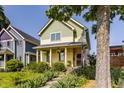 Two-story home with a cozy front porch adorned with hanging plants and a glimpse of neighborhood charm at 2020 N Park Ave, Indianapolis, IN 46202