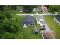 An aerial view of a beautiful home with a dark roof, green grass, and a detached garage at 2159 W 58Th Nw St, Indianapolis, IN 46228