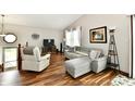 Bright living room showcasing wood floors, a comfortable sectional, and vaulted ceilings at 2442 N Willow Way, Indianapolis, IN 46268
