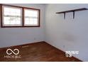 Bedroom featuring one window, a shelf, and hardwood floors at 26 Crescent Ct, Chesterfield, IN 46017