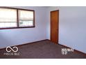 Small bedroom with a single window and carpet flooring at 26 Crescent Ct, Chesterfield, IN 46017