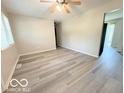 A well-lit living room features new gray floors and ceiling fan at 3106 Southwest Dr, Indianapolis, IN 46241