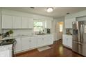 Bright kitchen with white cabinets, marble countertops, and stainless steel appliances at 3225 25Th St, Columbus, IN 47203