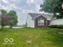 Exterior view of the house showing the lawn that stretches toward a pond at 3861 Indigo Blue Blvd, Whitestown, IN 46075