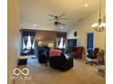 Spacious living room with high ceilings, a ceiling fan, and a fireplace at 3861 Indigo Blue Blvd, Whitestown, IN 46075