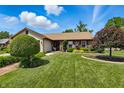 Inviting single-story house with a lush green lawn and mature landscaping at 3916 St Simons Ct, Indianapolis, IN 46237