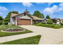 Well-maintained home with a long driveway and beautiful front yard with tasteful landscaping at 3916 St Simons Ct, Indianapolis, IN 46237