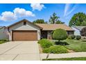 Lovely home boasting a well-kept lawn and a convenient two-car garage at 3916 St Simons Ct, Indianapolis, IN 46237