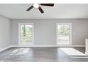 Spacious living room featuring large windows, neutral walls, and modern vinyl flooring at 496 N County Road 325 W, Danville, IN 46122