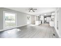 Bright, open-concept living area with lots of natural light and modern gray vinyl flooring at 496 N County Road 325 W, Danville, IN 46122