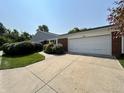 A well-maintained home featuring a brick facade, a two-car garage, and a concrete driveway at 5491 Vin Rose Ln, Lawrence, IN 46226