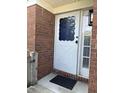 An inviting front door with decorative glass accents and brick surround, complete with a welcome mat at 5491 Vin Rose Ln, Lawrence, IN 46226