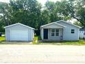 Charming single-story home featuring a detached garage and a welcoming front porch at 620 S 2Nd St, Noblesville, IN 46060