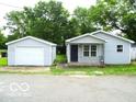 Charming single-story home featuring a detached garage and tidy front yard at 620 S 2Nd St, Noblesville, IN 46060