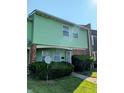 Two-story home with green siding, brick accents, satellite dish, and well-maintained landscaping at 6322 Commons Dr, Indianapolis, IN 46254